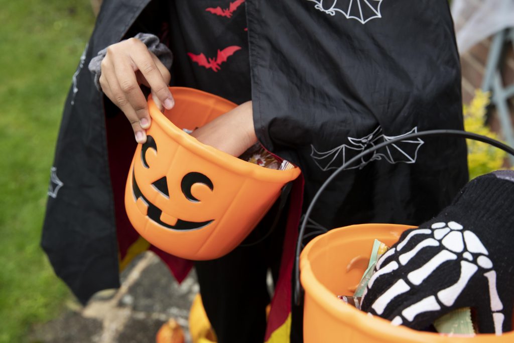 kids holding their trick treat buckets